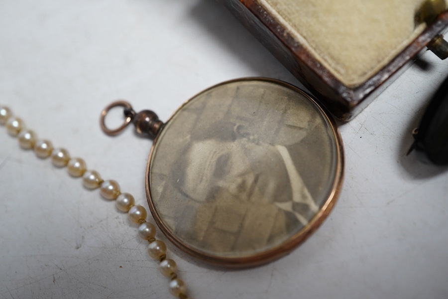 A marcasite ring, a pearl necklace, the garnet and split pearl clip, stamped 9ct, a black onyx and split pearl brooch and a 9ct gold photo pendant frame. Condition - fair